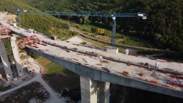 Highway bridge under construction. Aerial view of nes road. Freeway being built on a mountain terrain..