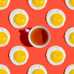 Seamless pattern with cup of tea and sunny side up egg for tasty breakfast on red background.