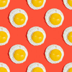 Seamless pattern with sunny side up egg on red background.