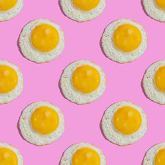 Seamless pattern with sunny side up egg on pink background.