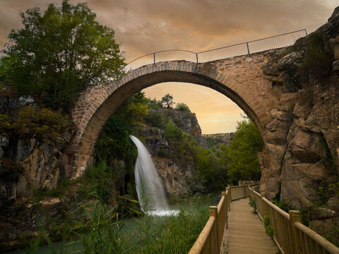 Clandras bridge and waterfall at sunset.  It is a Phrygian period structure. The most important touristic and historical places of Usak province. Touristic and historical buildings of Turkey. 