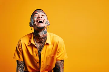 Foto op Aluminium Young man with neck and face tattoos smiling happy face laughing © blvdone