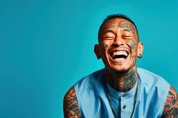 Foto op Aluminium Young man with neck and face tattoos smiling happy face laughing © blvdone