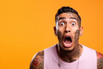 Young man with neck and face tattoos shocked reaction face - obrazy, fototapety, plakaty