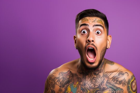 Young man with neck and face tattoos shocked reaction face