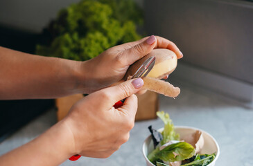hands of cook cut peel of raw potatoes , peeler, put food waste in separate container for further...