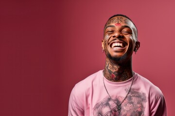 Young man with face and neck tattoos smile happy face