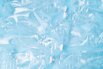 Plastic empty bottles on blue background. Copy space close up background. Recycling concept.