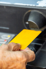  Closeup, hand insert the credit card in the ATM 