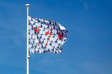 Flag of Concarneau waving atop of its pole