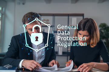 Businesspeople in formal wear taking notes signing contract at office workplace. Concept of important working moments, document sign, working process, concentration. GDPR hologram