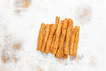 Italian grissini or salted bread sticks with sesame seeds.