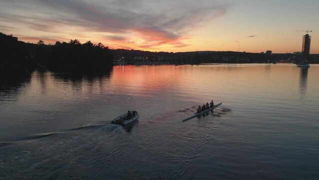 Aerial View of a Sport Canoe Being Driven by a Team of Young Women in Ocean 