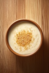 A bowl of appetizing spiced cream soup . On a wooden table. Simple, hearty, hot, homemade food. Comfort food concept. Insert in a design or project. top view