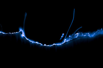 blue burning paper, glowing edge of paper on a black background