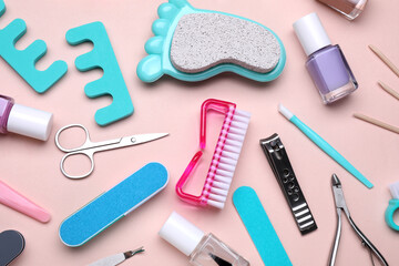 Set of pedicure tools on pink background, flat lay