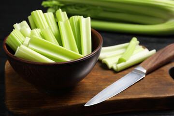 Fresh cut celery and knife on table, closeup