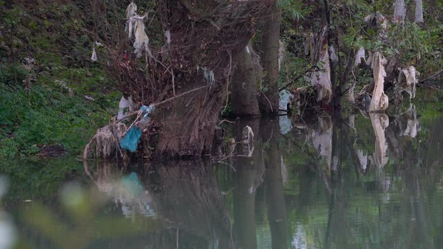 Garbage and plastic waste on water - (4K)