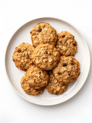 Top view of fresh baked oatmeal cookies on baking rack, white plate and white background	