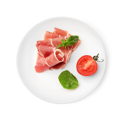 Plate with rolled slices of delicious jamon, cut tomato and basil isolated on white, top view
