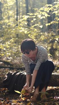 mom with her son in the garden with there dog sitting and playing near the trees