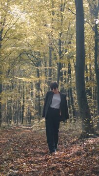 mom with her son in the garden with there dog sitting and playing near the trees