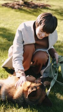 mom with her son in the garden with there dog sitting and playing near the trees