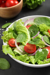 Delicious vegetable salad on grey table, closeup