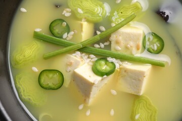 Bowl of delicious miso soup with tofu, top view