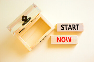 Start now symbol. Concept words Start now on beautiful wooden block. Beautiful white table white...