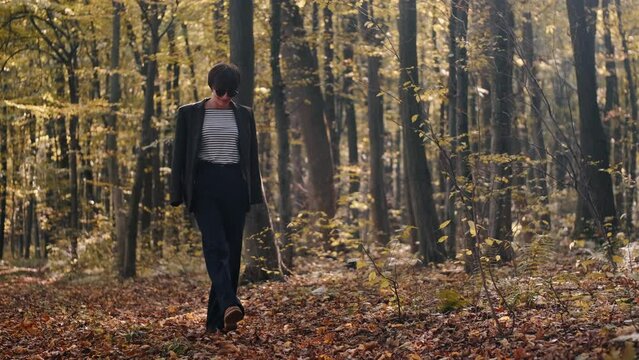 mom with her son in the garden with there dog sitting and playing near the trees