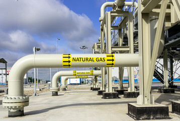 A row of pipes on a gas transport installation with the inscription natural gas