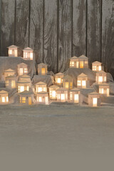 Advent calendar out of 24 self small made white round paper houses illuminated from the inside on...