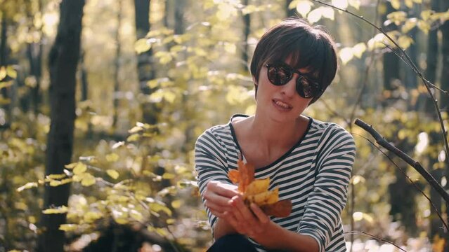 mom with her son in the garden with there dog sitting and playing near the trees
