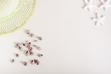 Summer light background for vacation with seashells, starfish and hat top view