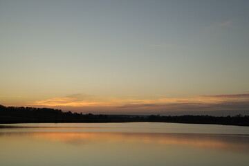 Fototapeta na wymiar Beautiful sunset by the lake in a countryside