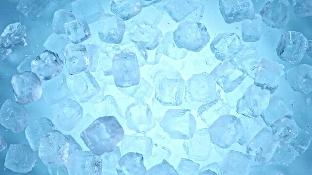 Super slow motion of falling ice cubes separated on blue background. Filmed on high speed cinema camera, 1000 fps.