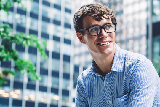 Smiling male using tablet sitting on bench
