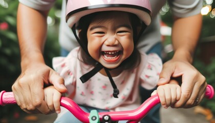 Close-up photo, a little girl wearing a slightly oversized helmet is being taught how to ride a bicycle by her father - obrazy, fototapety, plakaty
