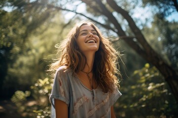 Fototapeta premium happy woman posing against a background of trees