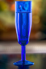 Blue champagne glass with selective focus