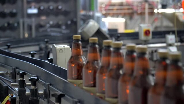Technological line for bottling of beer in brewery. Empty aluminum beer cans are moving along the conveyor beltTechnological line for bottling of beer in brewery. Empty aluminum beer cans are moving a