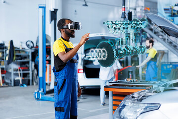 African american mechanic in repair shop using AR holograms to check car performance parameters during maintenance. Certified garage employee using futuristic vr headset to examine damaged vehicle
