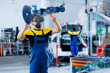Technician in car service using holographic augmented reality device to repair broken motor....