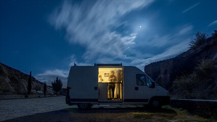 Camper van with opened door in the moonlight at night, Hoces del Duraton natural park, Sepulveda, Segovia, Spain © Sebastian