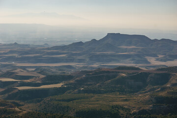 View of the Bardena Negra or Bardena black desert landscape of Bardenas Reales with vegetation,...