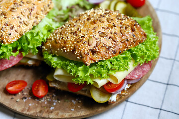Salami sandwiches with pickles and lettuce.