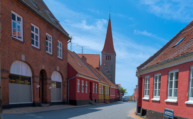 a traditional small,red,danish framehouse in summer in Bornholm with blue sky
