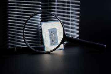 Modern powerful personal computer processor, a radiator for cooling it and magnifying glass....