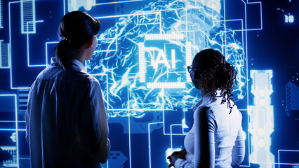 Engineering coworkers looking at hologram of artificial intelligence human brain simulation....
